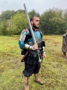 Knight of Ullr in full plate armor at Herofest LARP event - medieval fantasy roleplay kit.